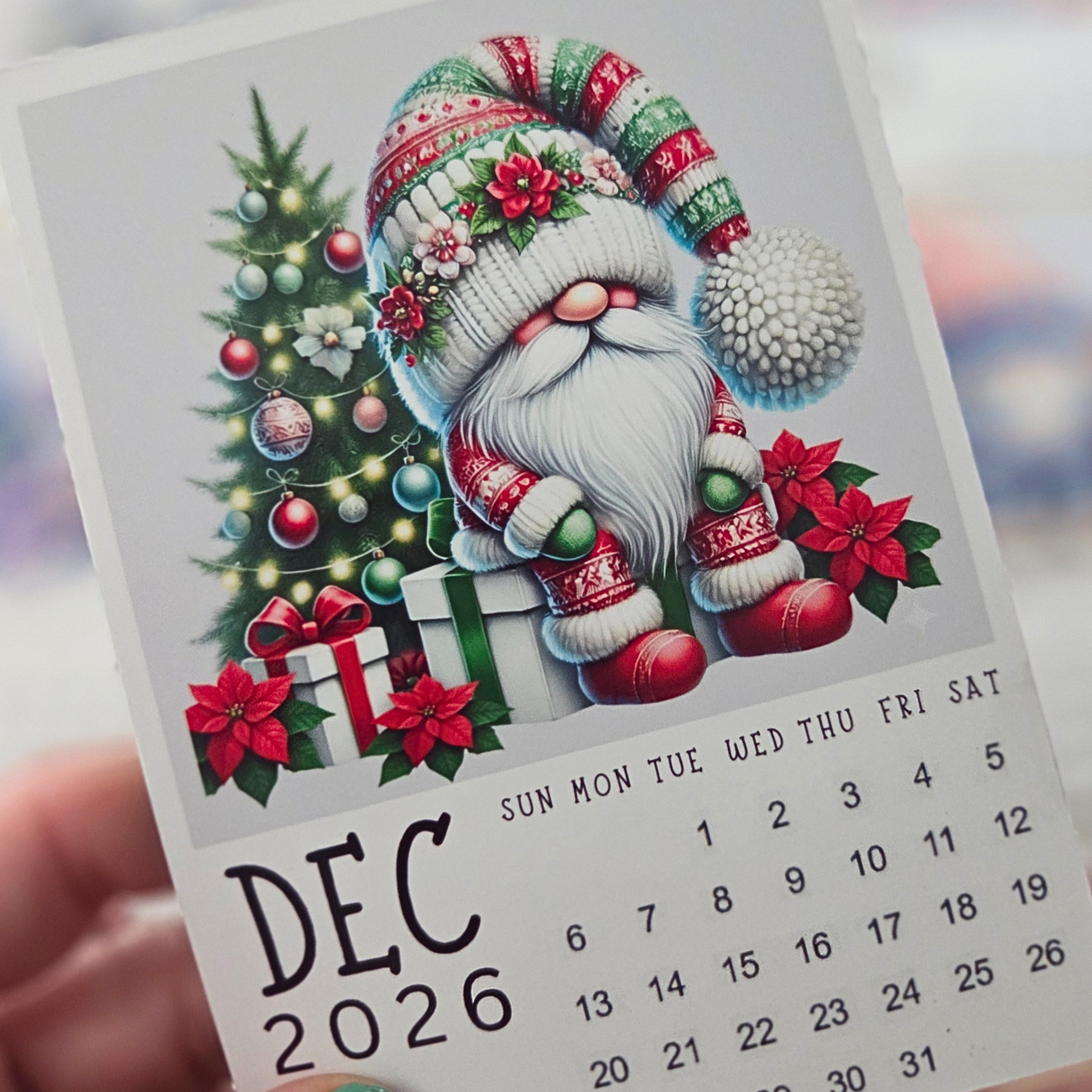 Handmade Christmas tree art project with decorative bottle caps on a wooden surface