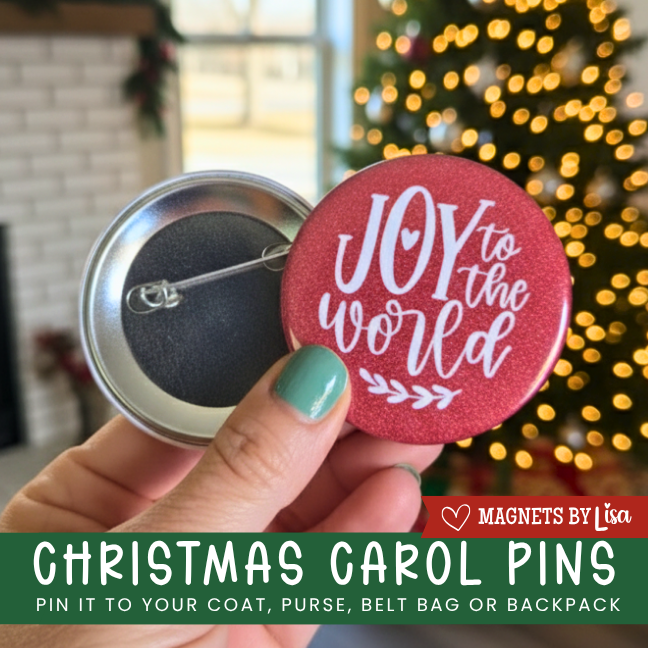 Person holding a 'Joy to the World' Christmas carol pin with a blurred festive background