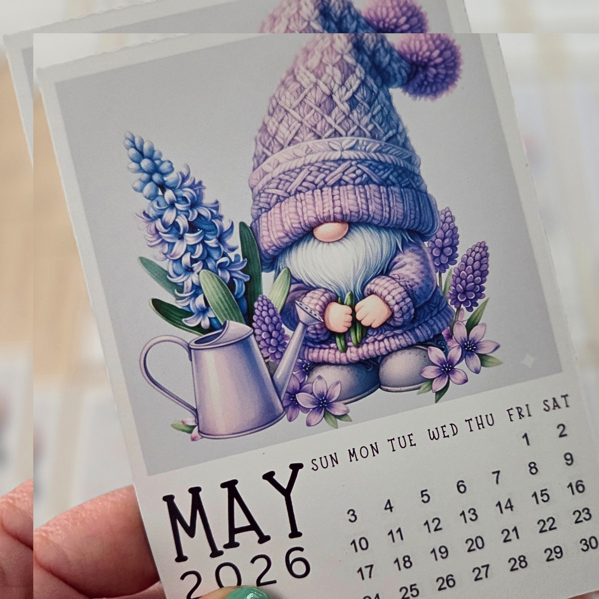 Calendar for May 2026 with a gnome and flowers illustration