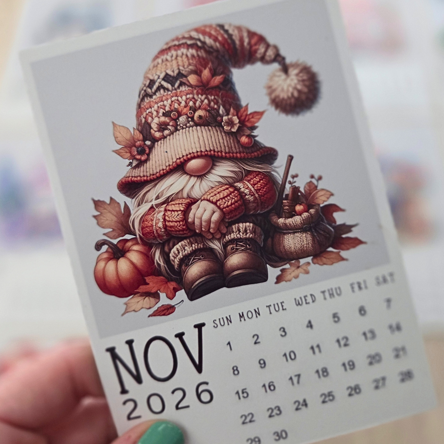 Calendar for November 2026 with a gnome illustration on a blurred background