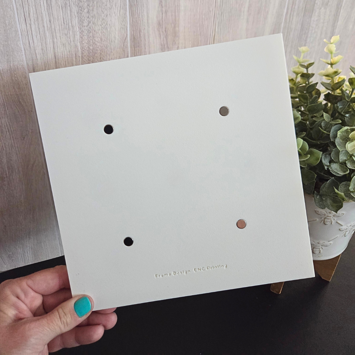 White 3D‑printed 3×3 magnetic frame with a decorative beaded border, designed to hold nine photo magnets in a clean grid layout, shown with removable feet and clearly labeled as holding 9 photo magnets.