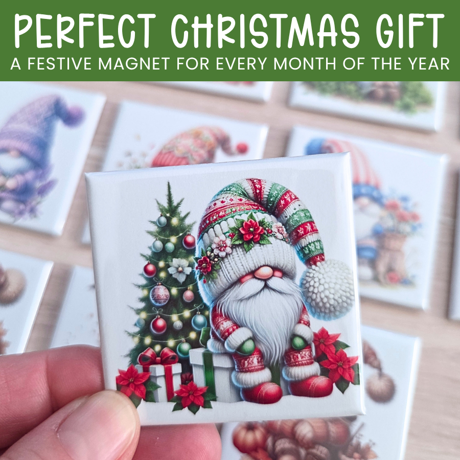 Festive magnet featuring a gnome with a Christmas tree and presents, held by a hand.