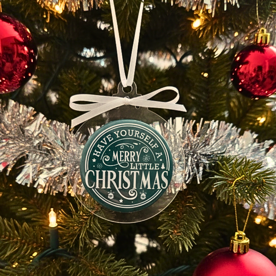 Decorative Christmas ornament with 'Have Yourself a Merry Little Christmas' text on a Christmas tree.