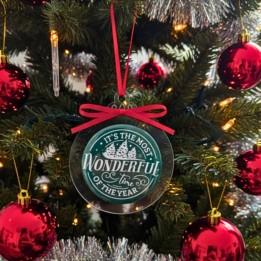 Decorative ornament with 'It's the Most Wonderful Time of the Year' text on a Christmas tree.