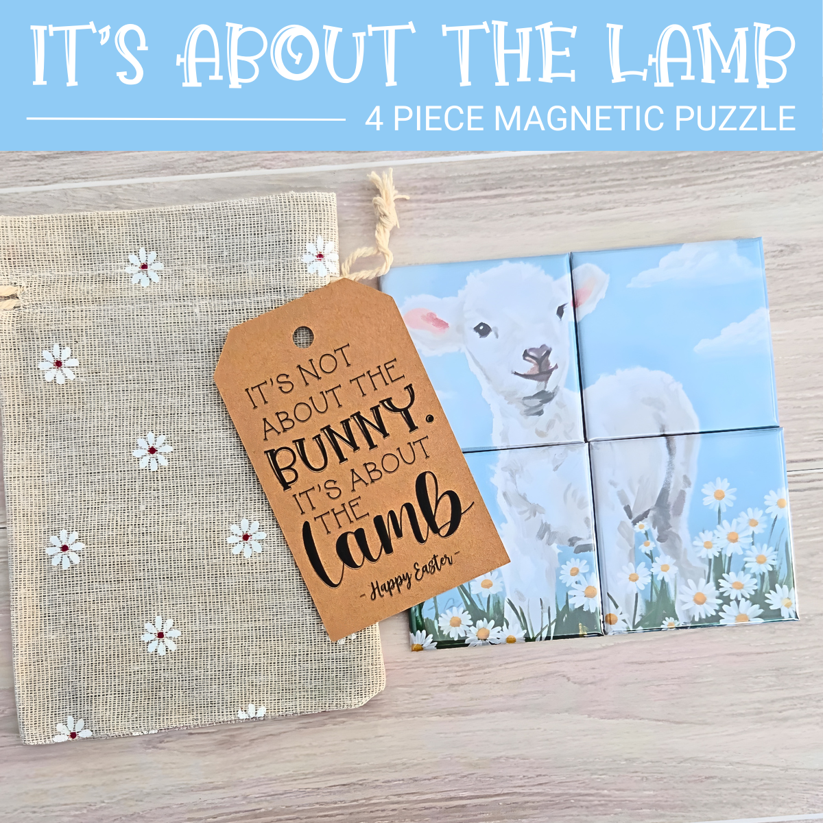 4‑piece mini magnetic Easter puzzle featuring a painted white lamb standing in a field of daisies under a bright blue sky. One small puzzle piece is shown separated to highlight the simple, toddler‑friendly design. Includes a floral drawstring gift bag and a brown Easter tag with a faith‑based ‘It's not about the bunny. It’s About the Lamb’ Easter message.