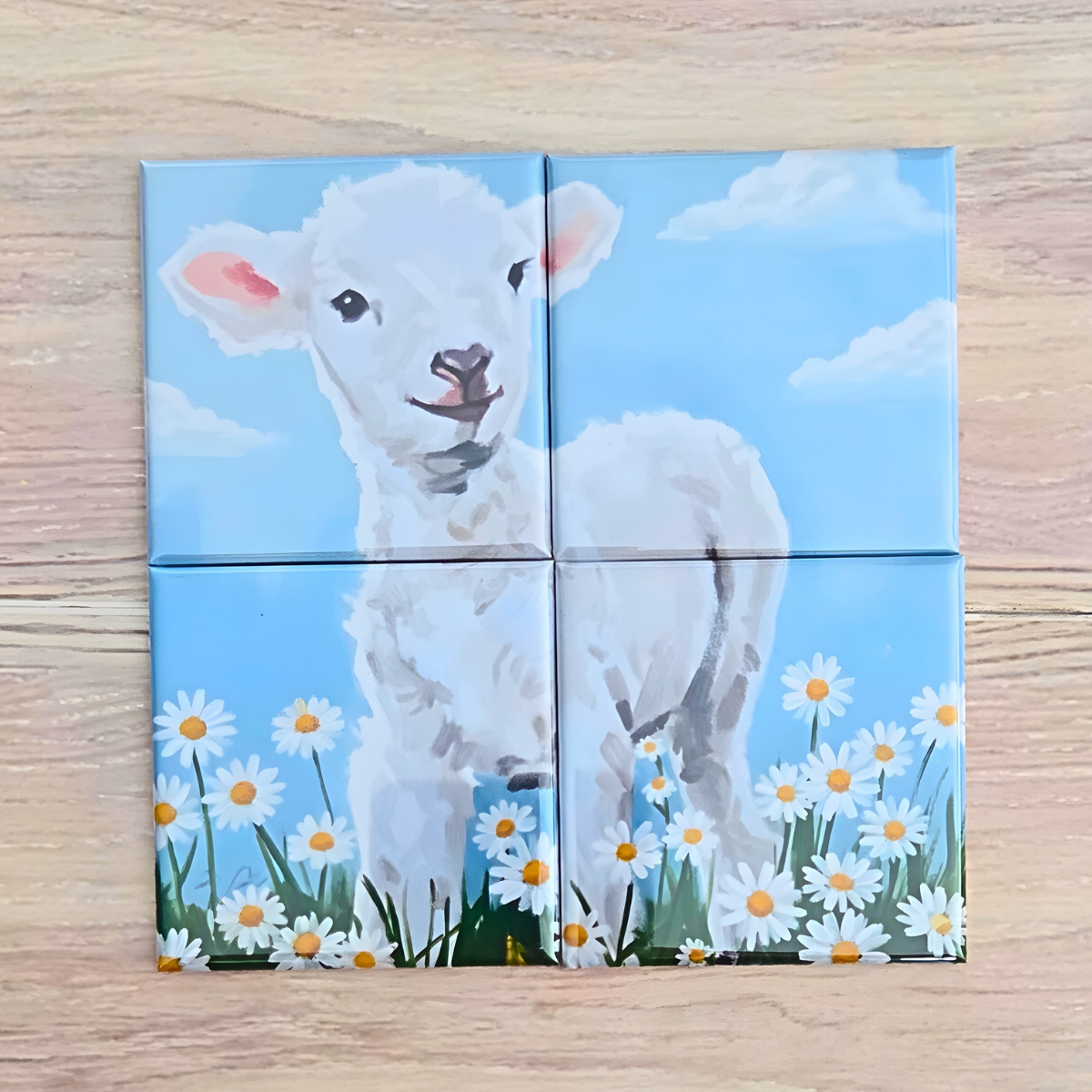 4‑piece mini magnetic Easter puzzle featuring a painted white lamb standing in a field of daisies under a bright blue sky.  This Lamb puzzle is to help teach the true meaning of Easter, Jesus Christ ‘It's not about the bunny. It’s About the Lamb’ Easter message