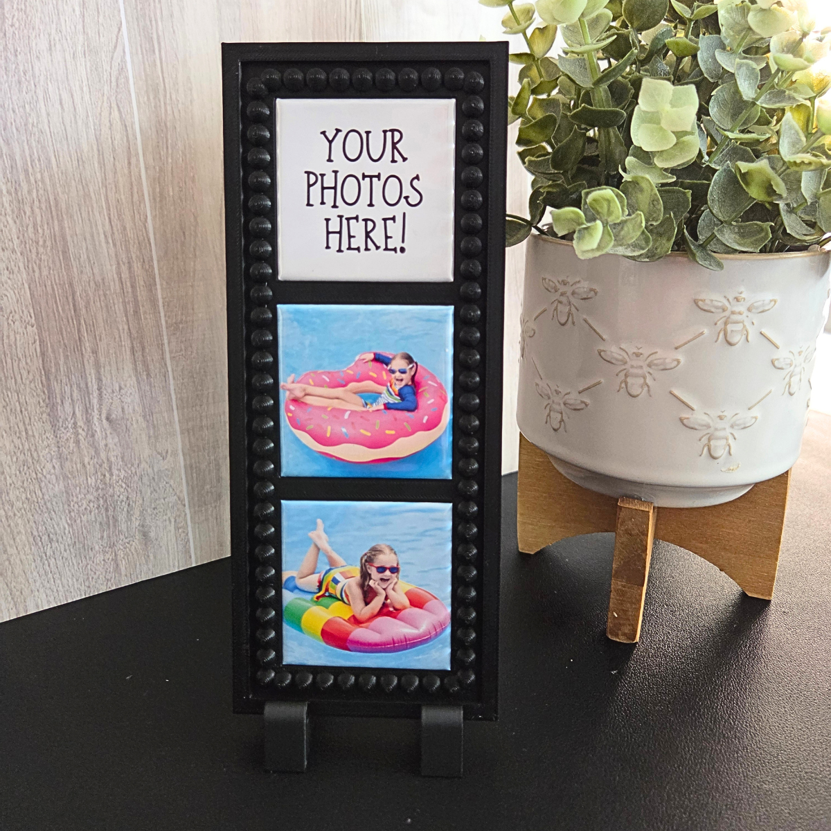 Black 1×3 magnetic display frame with built‑in front magnets and a decorative beaded border, shown upright for tabletop display.