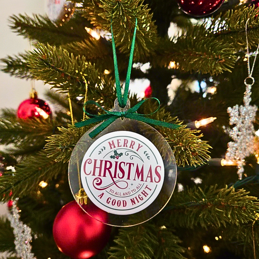 Decorative Christmas ornament with 'Merry Christmas to all and to all a Good Night' text on a Christmas tree.