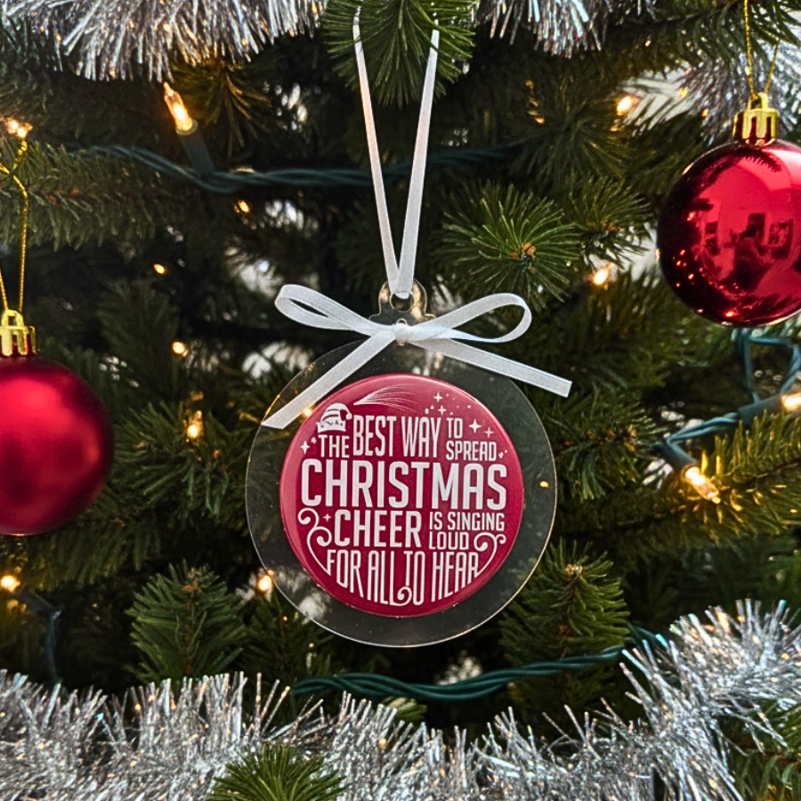 Decorative Christmas ornament with text on a Christmas tree.