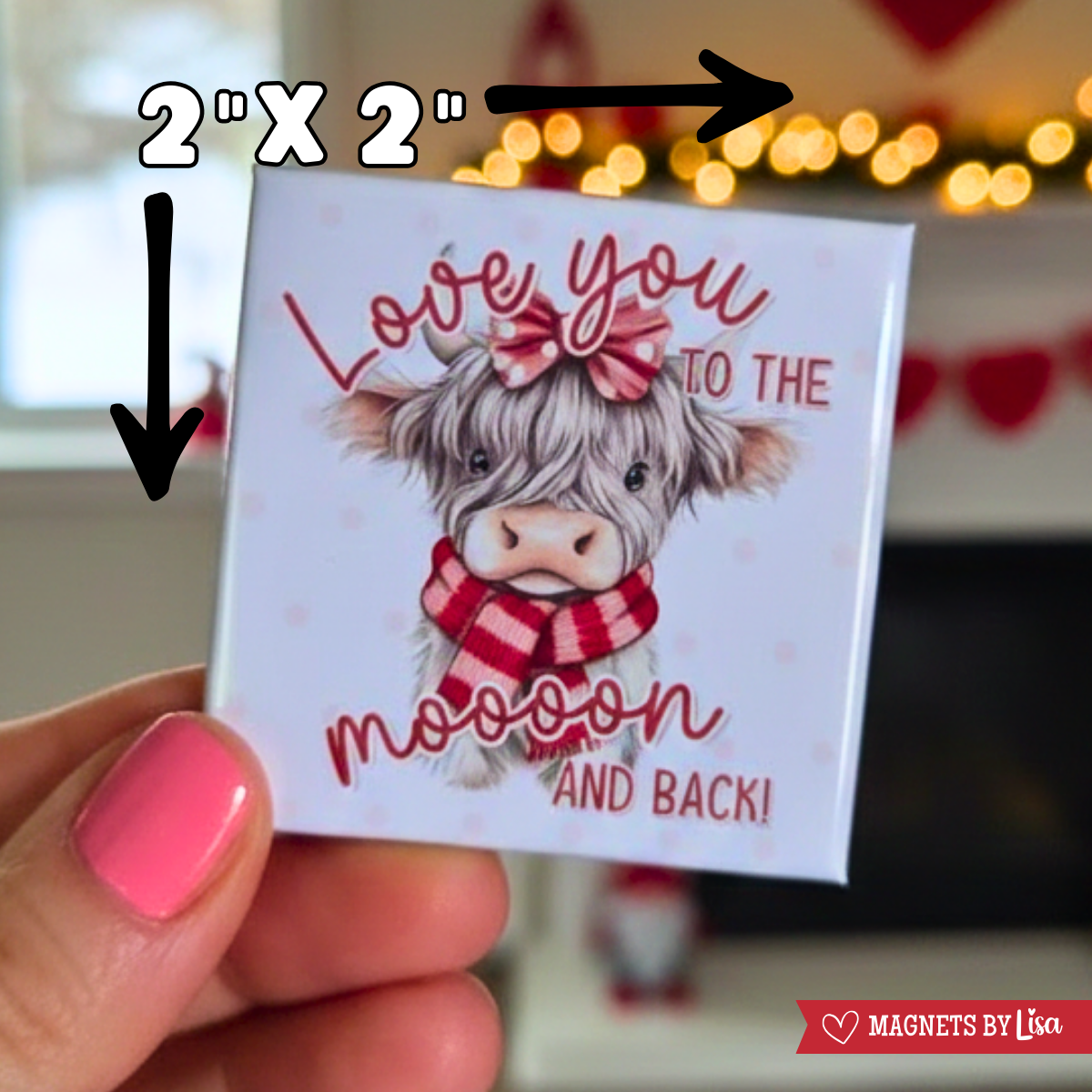 Magnet with a highland cow pun and the text 'Love you to the mooon and back' held by a hand.