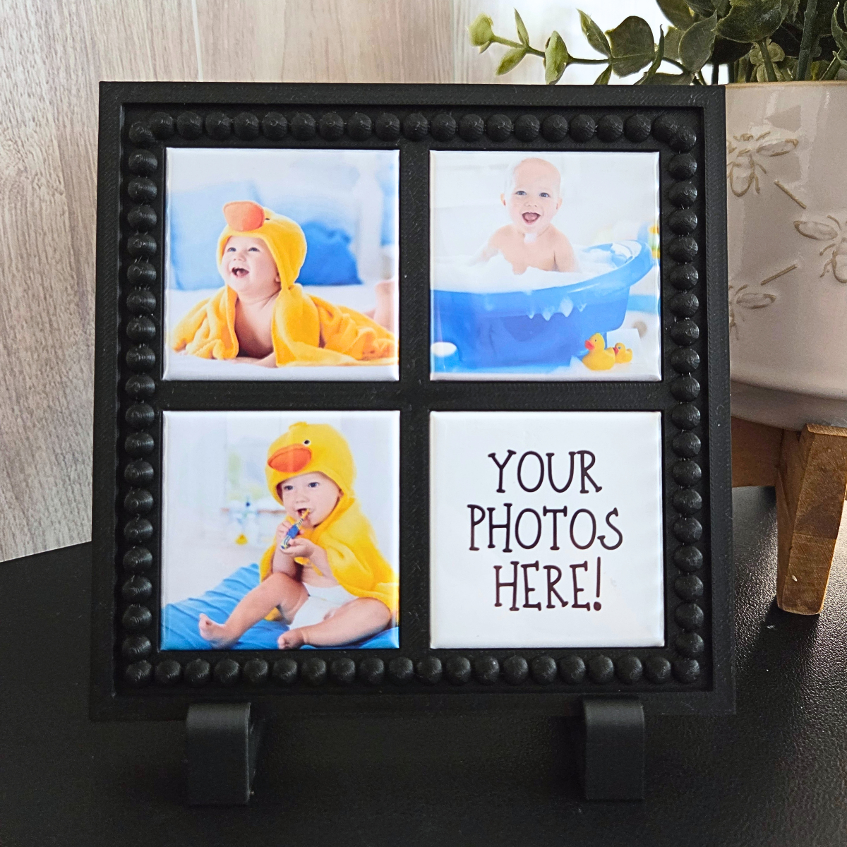 Black 3D‑printed 2x2 magnetic frame with a decorative beaded border, designed to hold 4 photo magnets in portrait or landscape orientation, shown with removable feet.