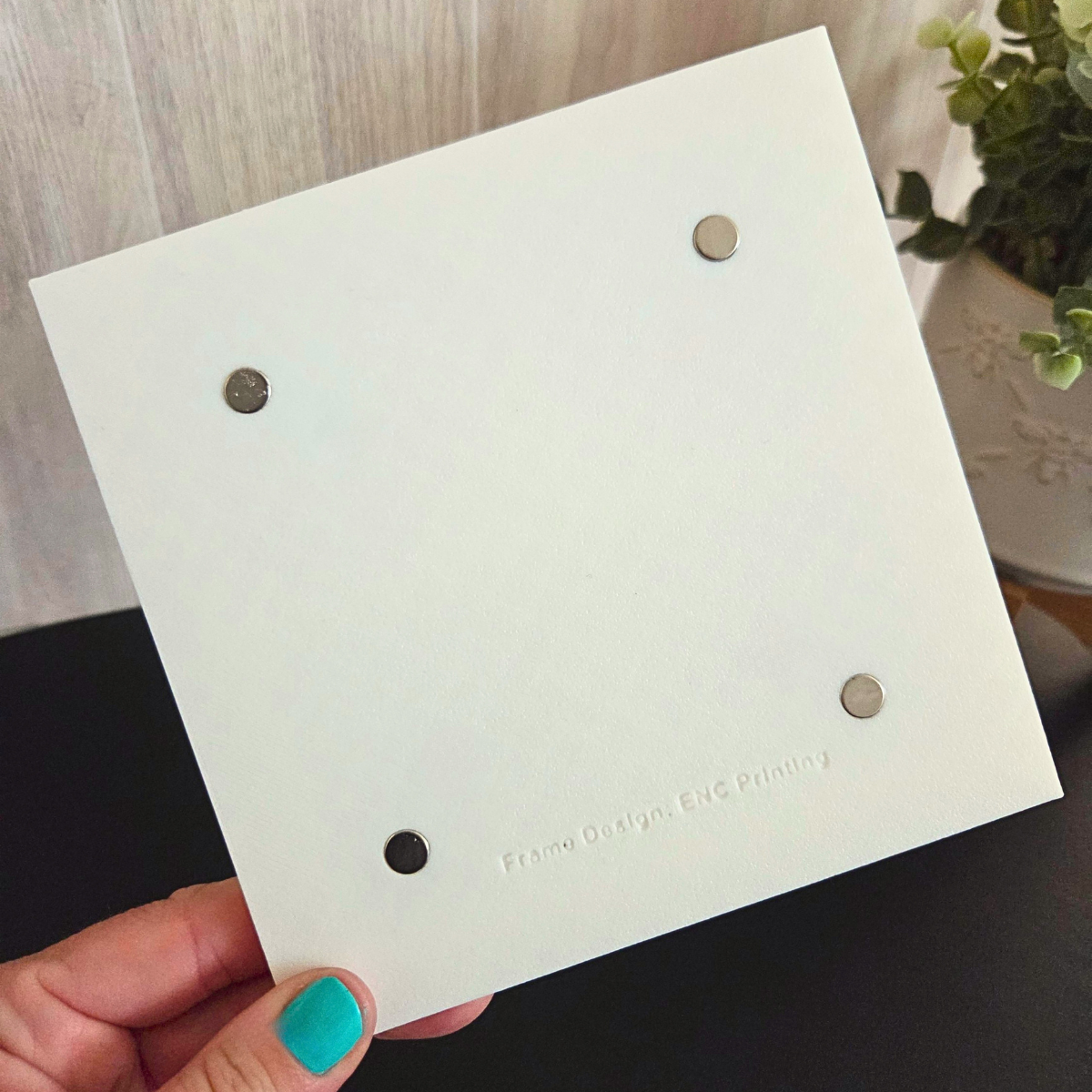 White 3D‑printed 2x2 magnetic frame with a decorative beaded border, designed to hold 4 photo magnets in portrait or landscape orientation, shown with removable feet. BACKSIDE