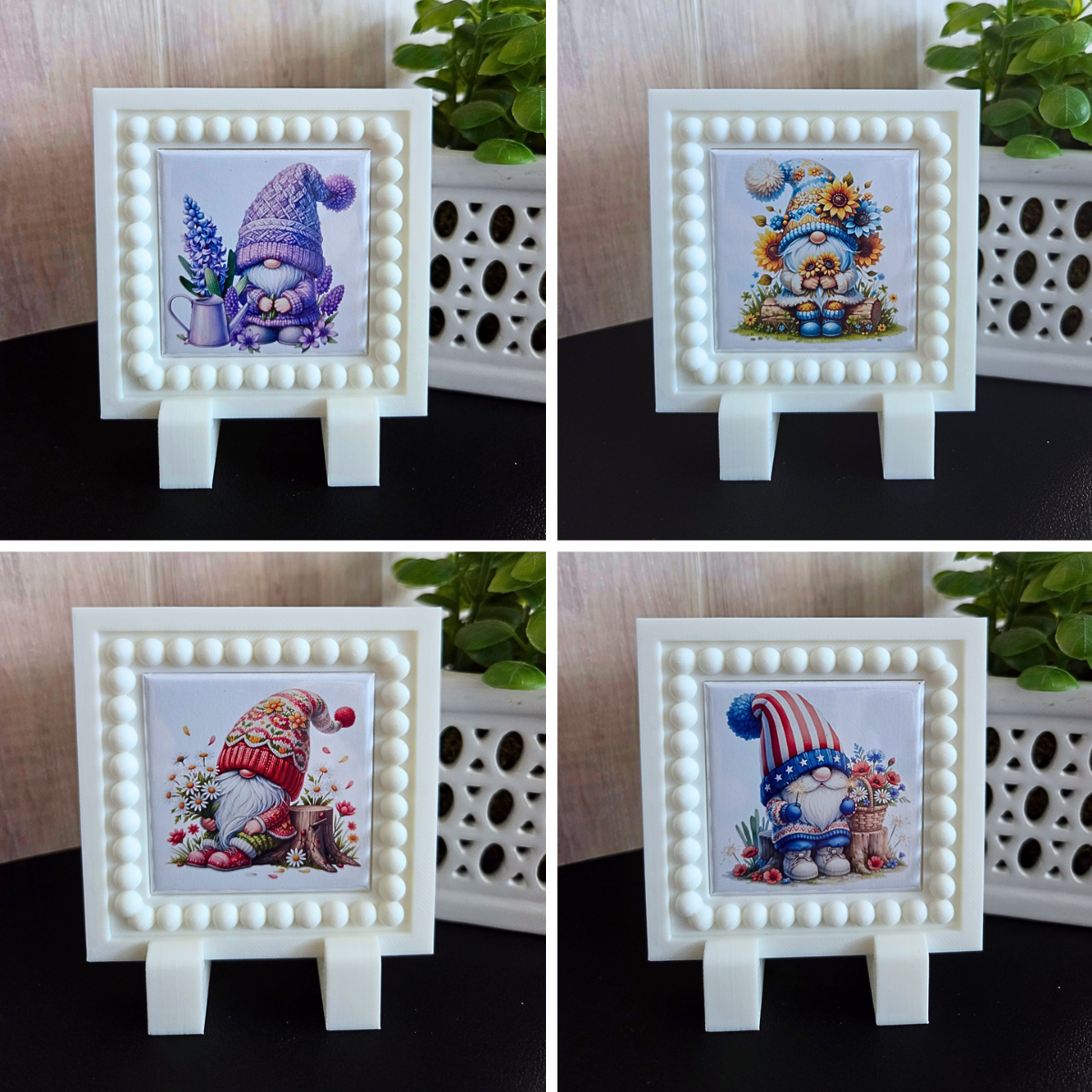 A curated set of twelve 2x2 seasonal gnome magnets displayed with a white 3D‑printed magnetic frame. Each magnet features a unique monthly gnome design, including Valentine hearts, spring flowers, summer themes, fall pumpkins, and winter holiday gnomes. The frame holds one magnet at a time for easy monthly swapping. A charming year‑round décor gift for gnome lovers, moms, and grandmas.