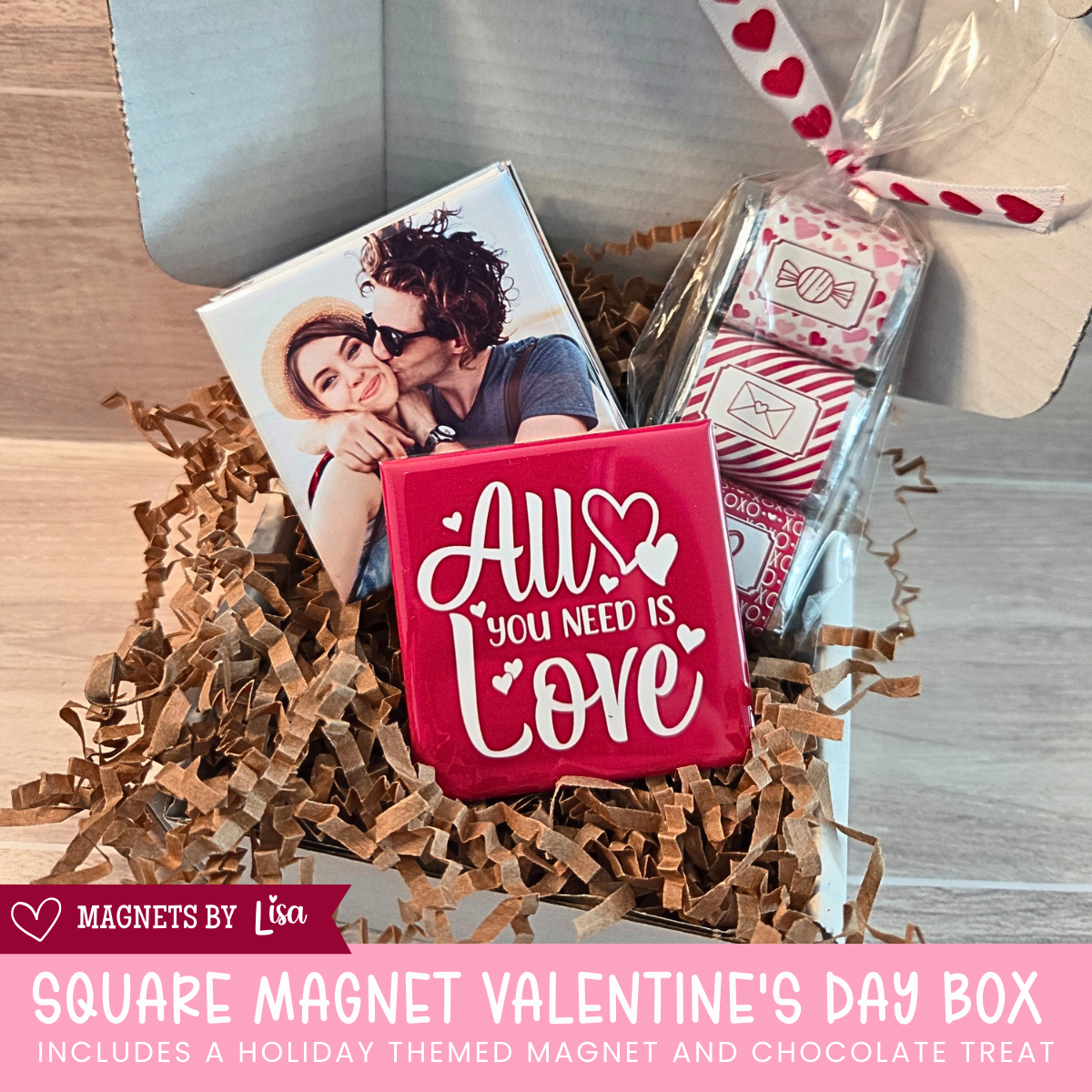 Valentine’s Day gift box with custom 2-inch square photo magnets, a All you Need is Love magnet, and a  trio of Hershey chocolate nuggets wrapped in pink and red Valentine-themed stickers.
