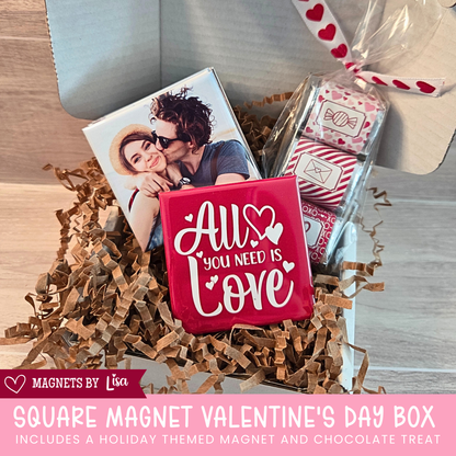 Valentine’s Day gift box with custom 2-inch square photo magnets, a All you Need is Love magnet, and a  trio of Hershey chocolate nuggets wrapped in pink and red Valentine-themed stickers.